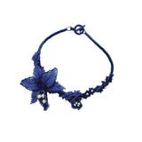 Luxury handmade jewelry with blue beads and floral design.