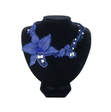 Luxury handmade jewelry with blue beads and floral design.